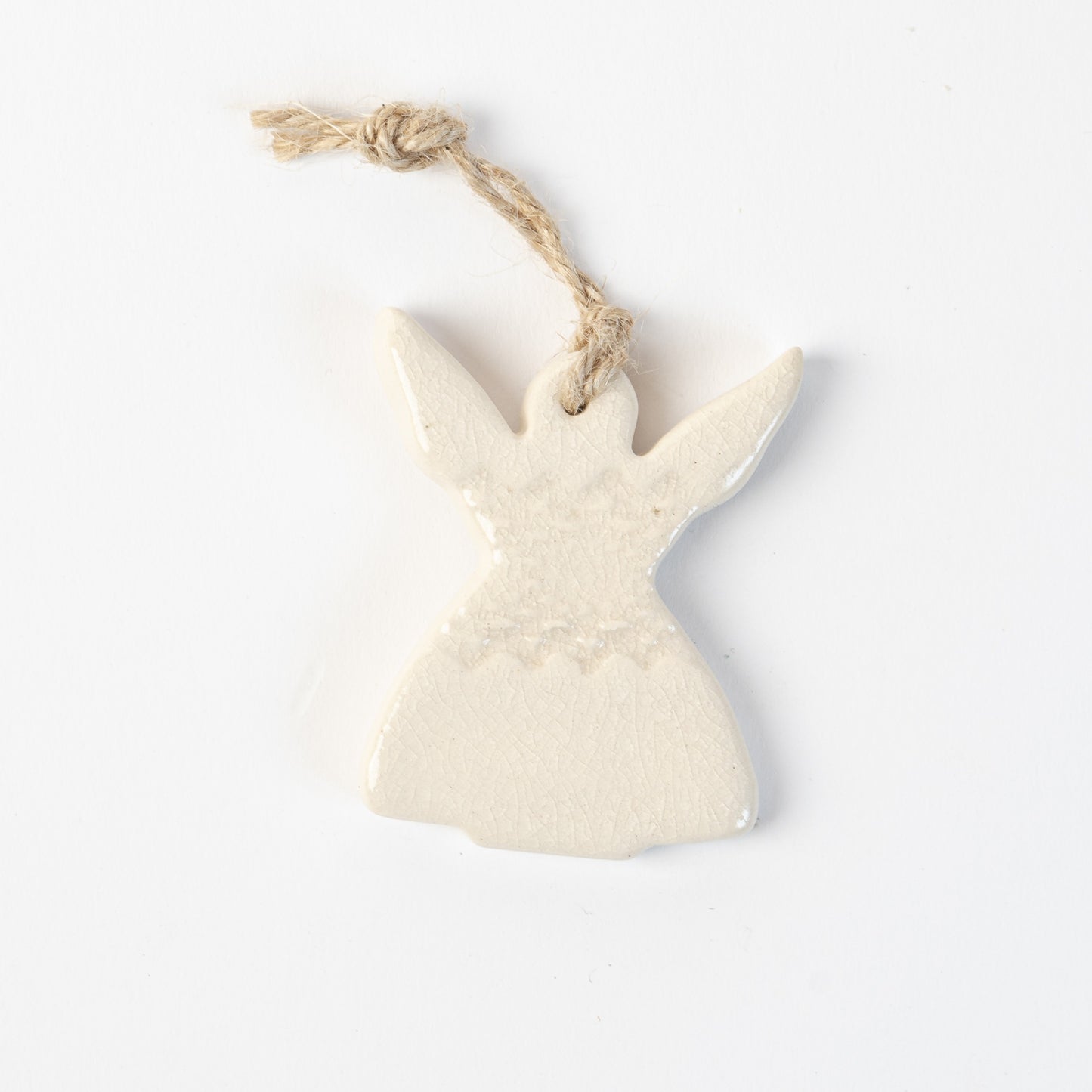 Ceramic angel in polar white ornament hanging on a white background made by the wirksworth pottery company