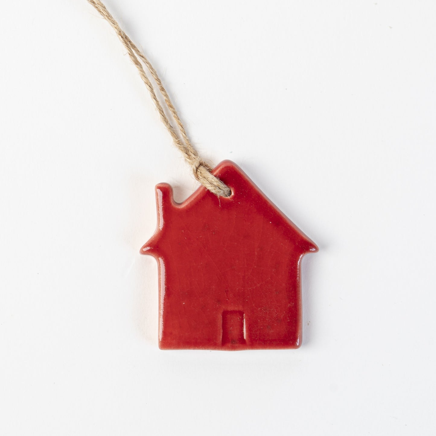 Candy cane red Ceramic house-shaped Christmas ornament made by the wirksworth pottery company.