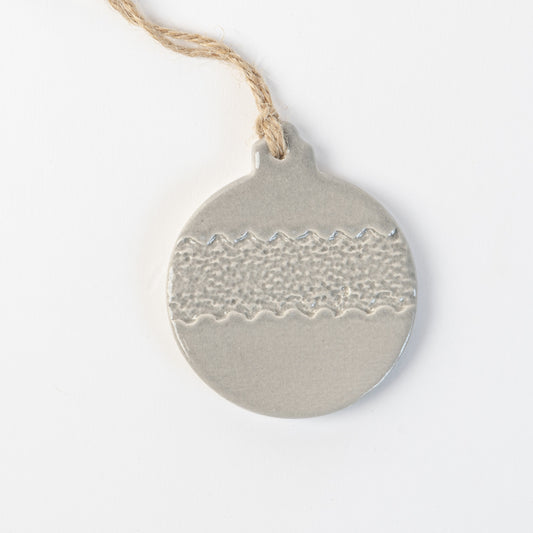 Grey frost textured ceramic bauble ornament hanging on a white background made by the wirksworth pottery company