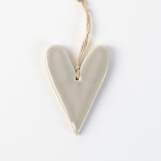 Grey Frost Heart-shaped ceramic ornament hanging on a rope against a white background
