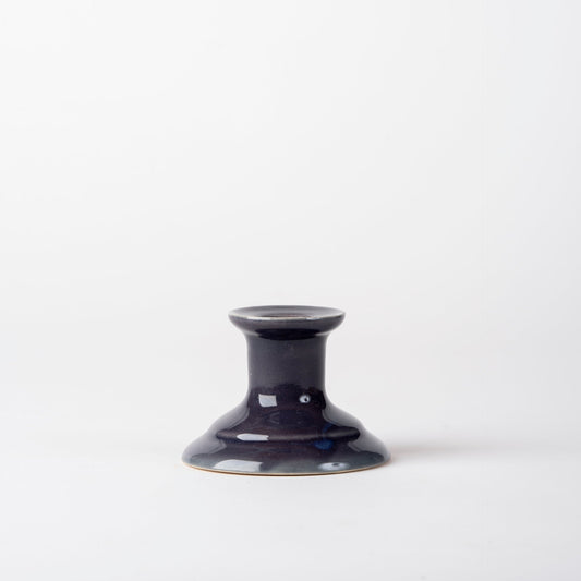 Dark blue ceramic candle holder on a white background
