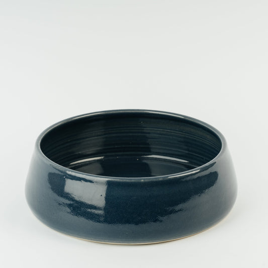 Dark blue ceramic dog bowl on a white background The Wirksworth Pottery Company