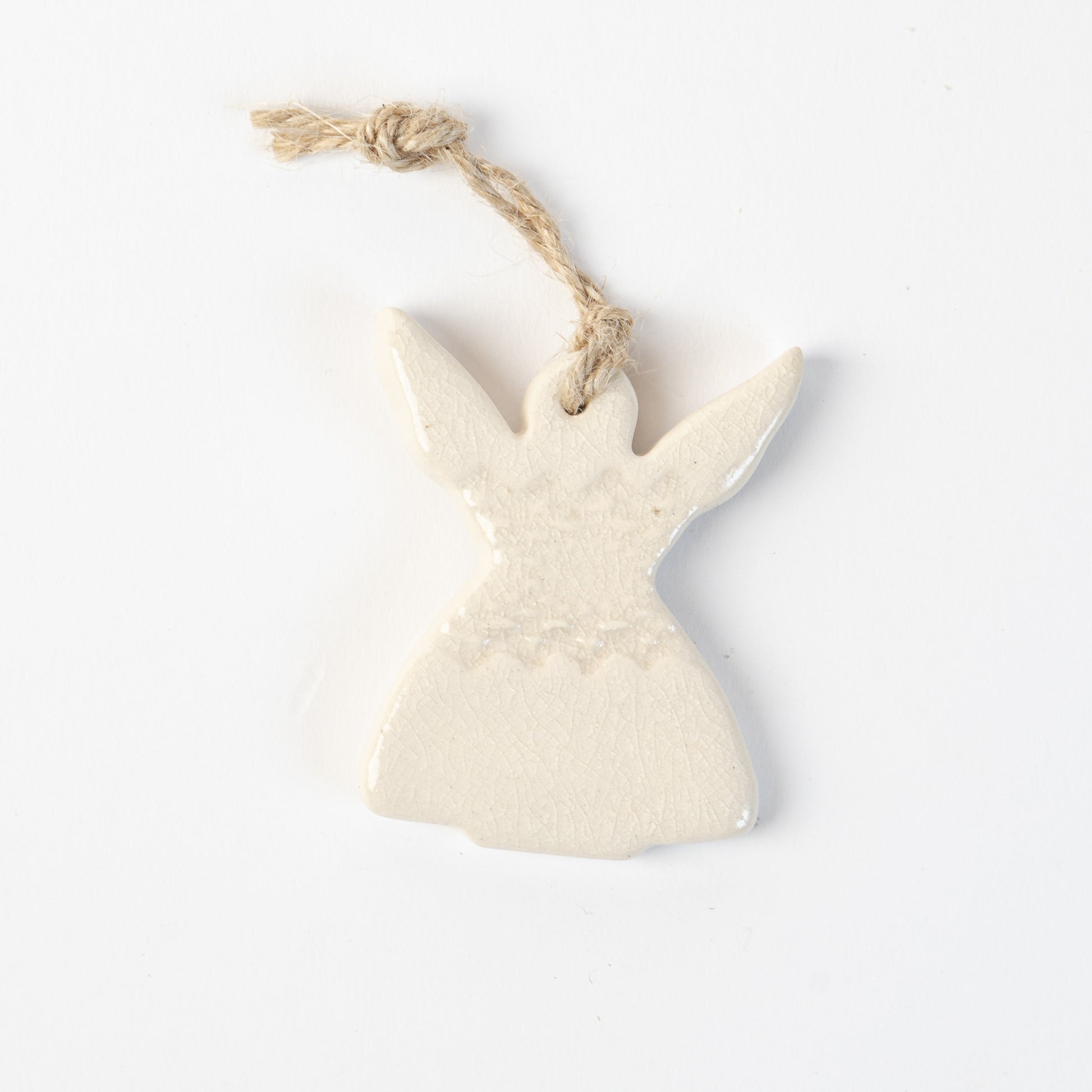 Ceramic angel in polar white ornament hanging on a white background made by the wirksworth pottery company