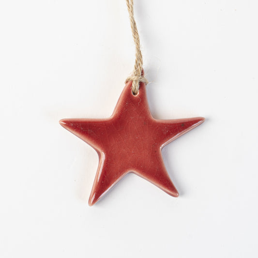 red Star-shaped ceramic ornament on a white background made by the wirksworth pottery company