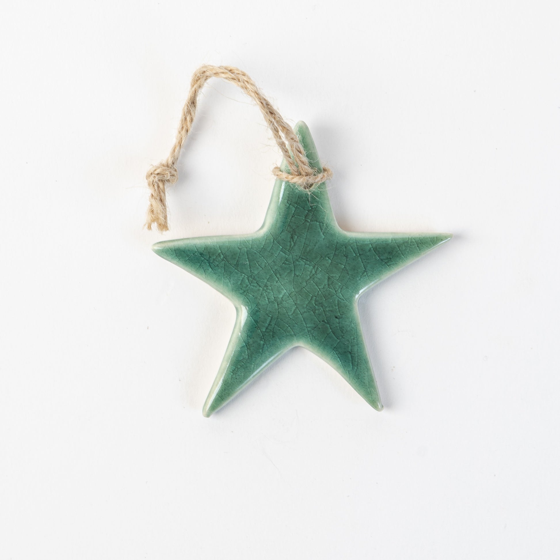 Fir green Star-shaped ceramic ornament on a white background made by the wirksworth pottery company
